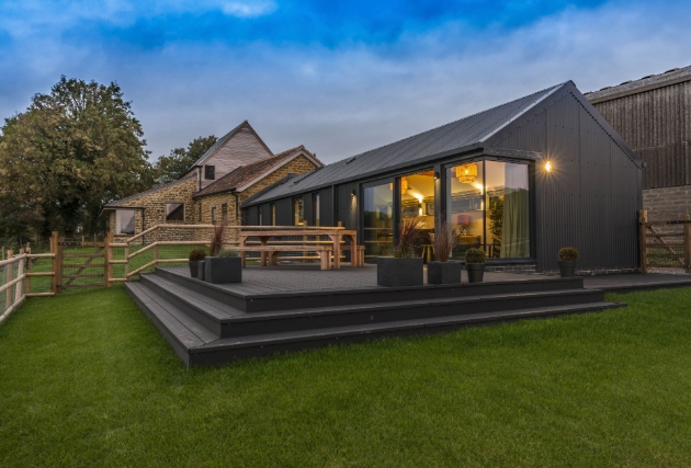 Nighttime view of holiday property in dorset with decking