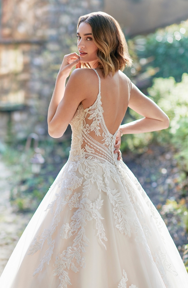 bride looking at camera over her shoulder in a dress made of Embroidered Cotton Lace/English Net/Organza/Stretch Lining