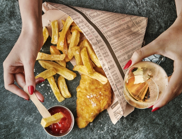 plate of fish and chips with a glass of champagne