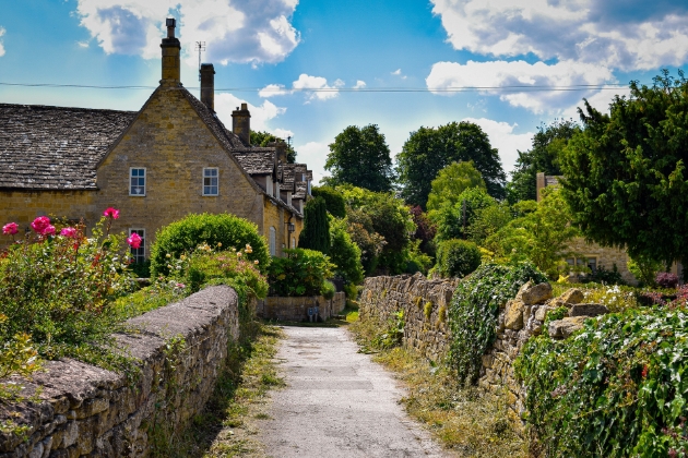 cottage at the nd of gravel path and gardens