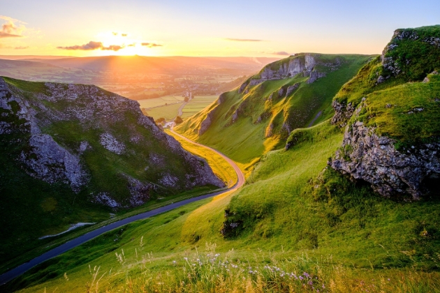 valleys at sunset with road passing through them