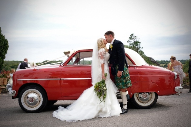 Couple in front of a car