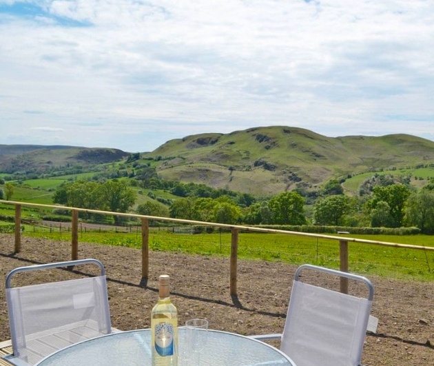 table and chair with view of hills