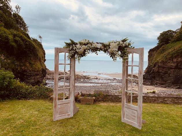 Wooden doorway on grass looking out to sea