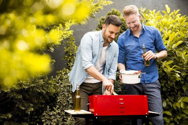 to men at barbecue in garden