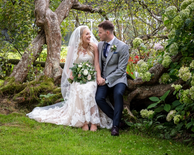 Couple sit on fallen tree