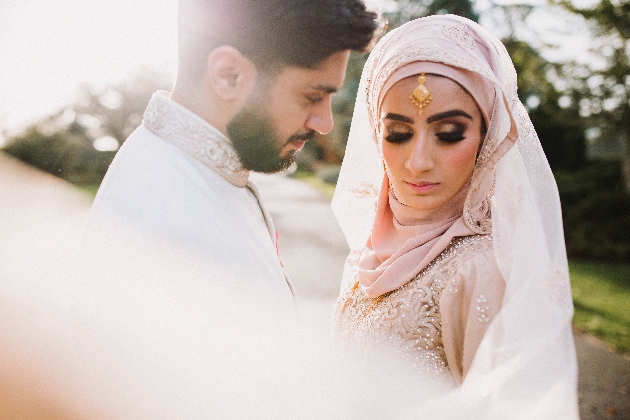 Bride looks away whilst groom looks at her