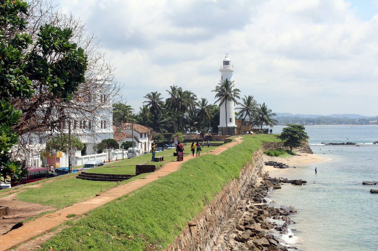 country house on the coast looking out to sea, has a white lighthouse on grounds