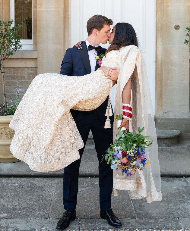 Groom carrying bride