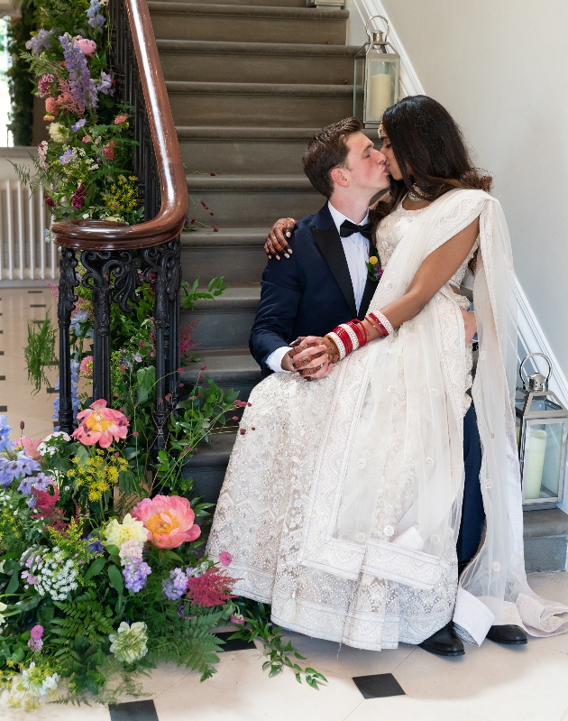 Bride sitting on grooms lap