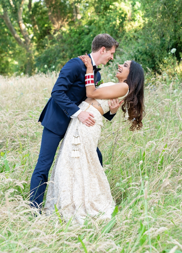 Couple laughing in meadow