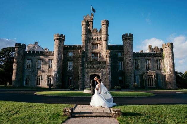 Bride and groom posing outside Hensol Castle