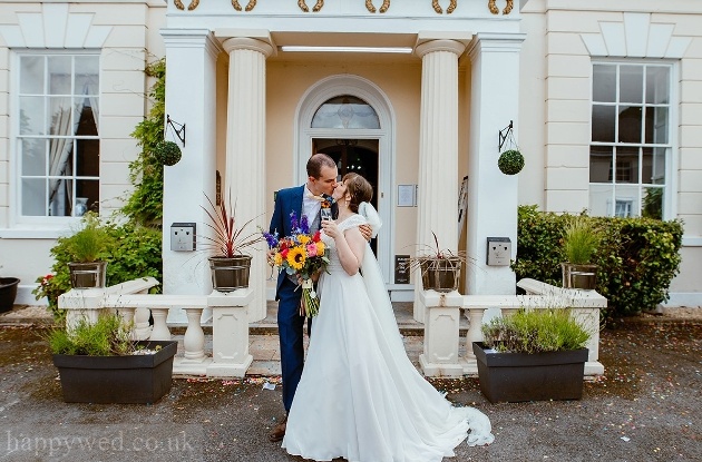 Bride and groom kissing outside Norton House Hotel