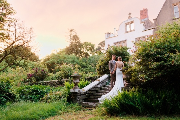 Bride and groom posing outside Rhosygilwen