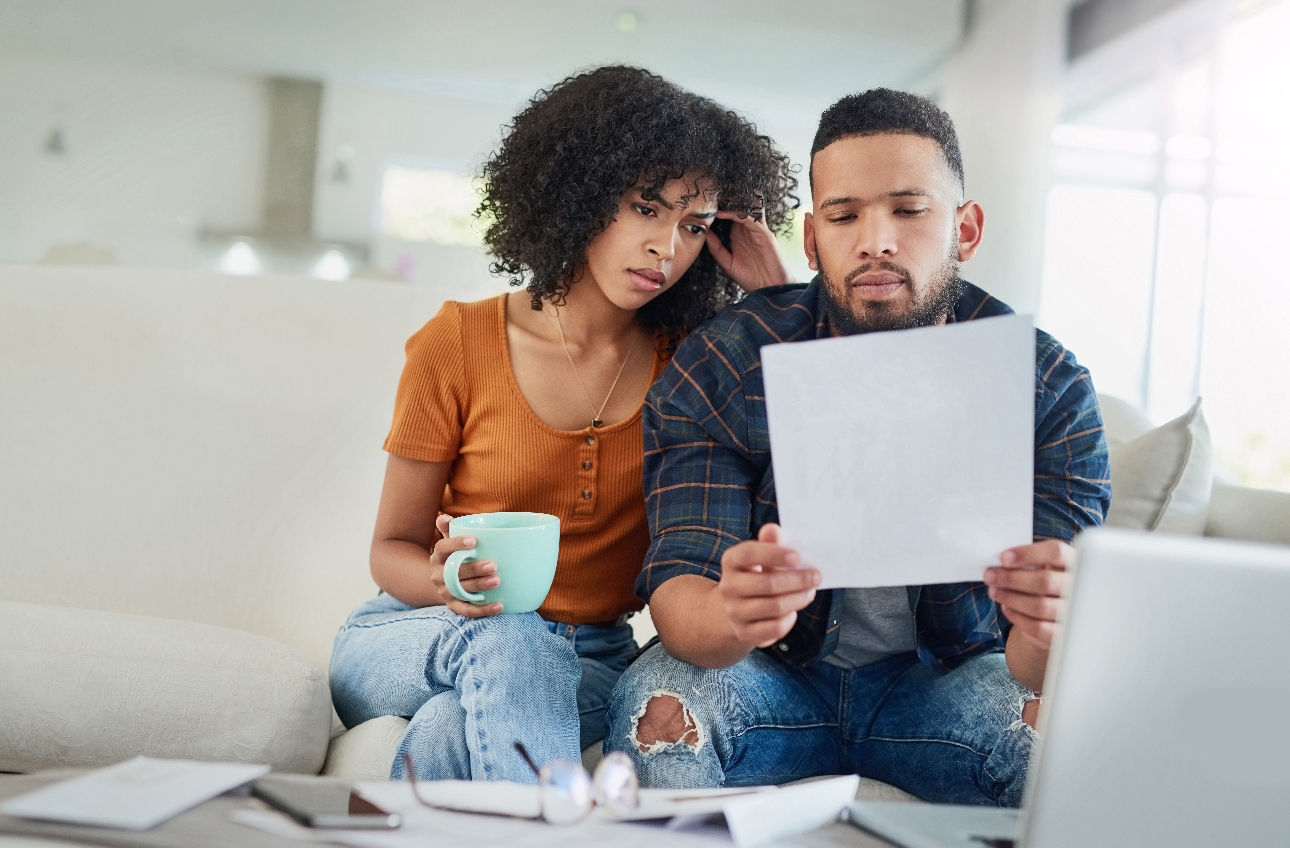 couple on sofa looking at laptop