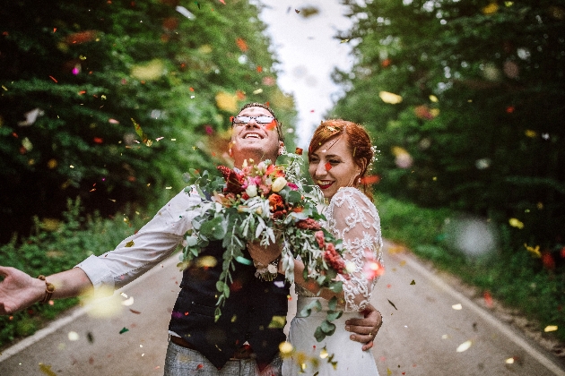 Bride and groom surrounded by confetti