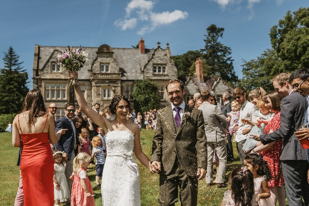 Bride and groom walking outside Rhosygilwen