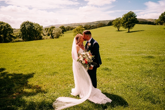 Bride and groom in a field