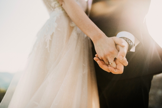 Bride and groom holding hands