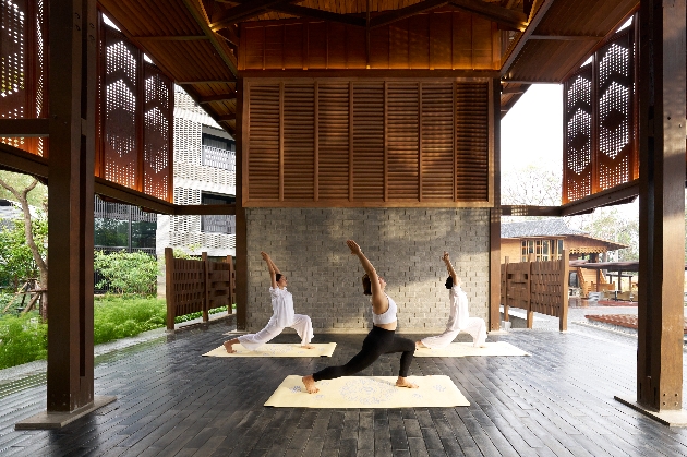 Three women doing yoga at Aleenta Retreat Chiang Mai