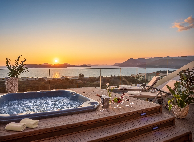 A hot tub and seating overlooking the sunset