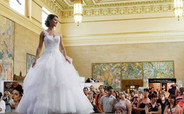 Woman in a wedding dress walking down a catwalk