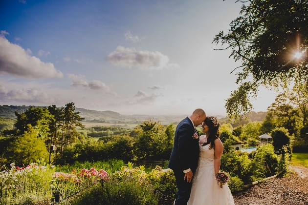 Bride and groom embracing in a garden