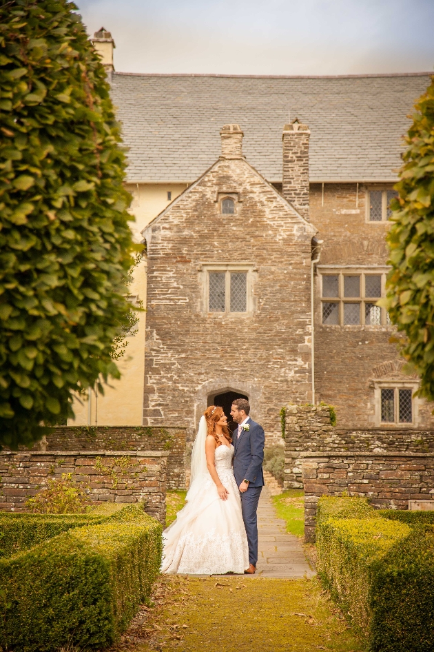 A couple embracing outside Llancaiach Fawr Manor