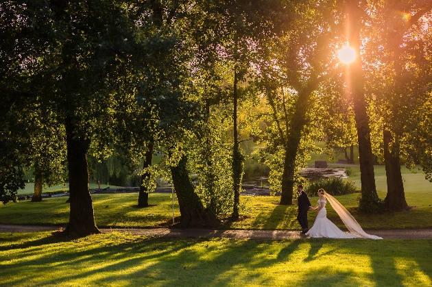 Bride and groom walking in the grounds of The Vale Resort