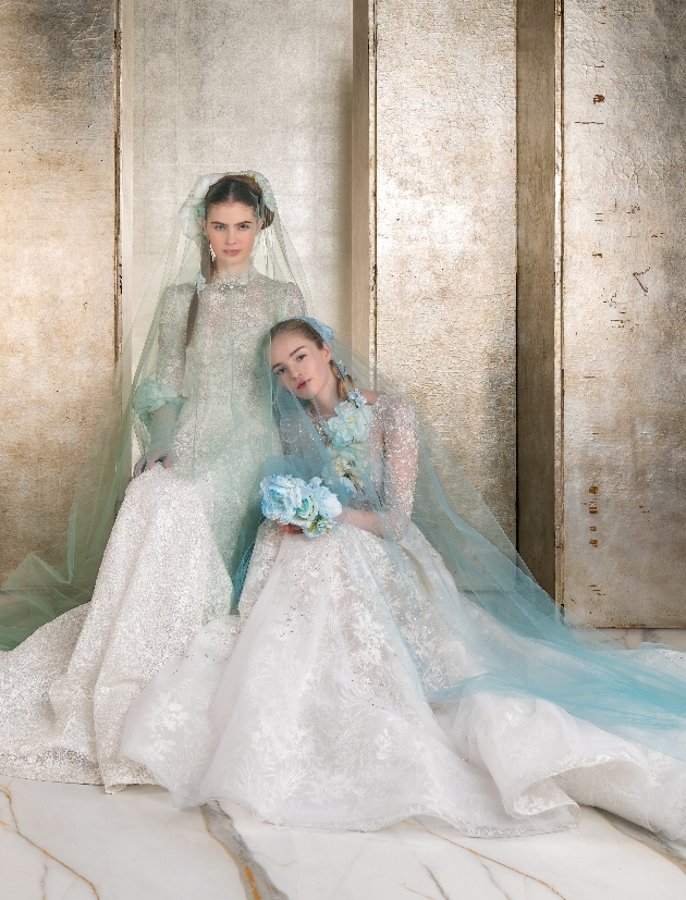 two models in high neck long sleeve jewel gowns with cathedral coloured veils