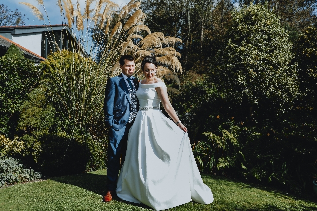 A bride and groom embracing in a garden