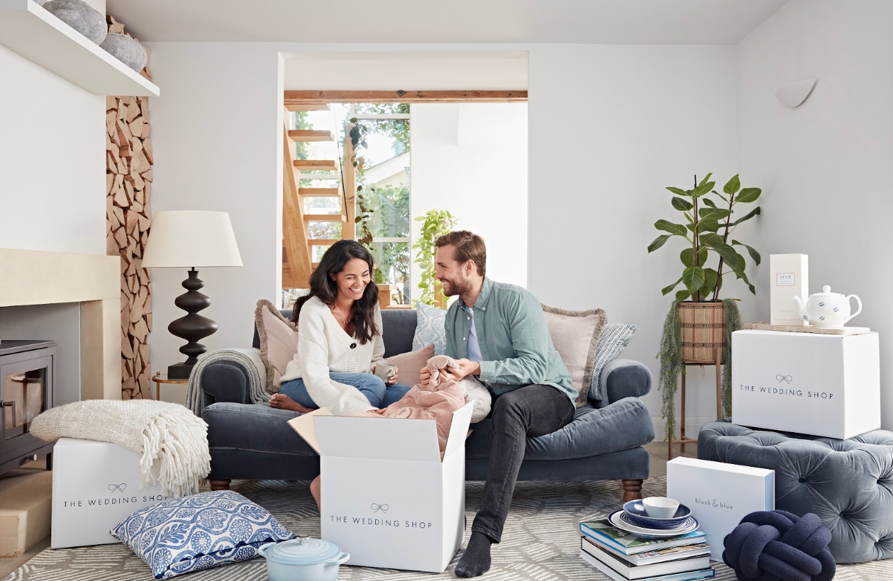 couple opening presents on sofa together