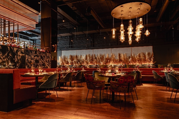 Several tables in a wooden-inspired restaurant