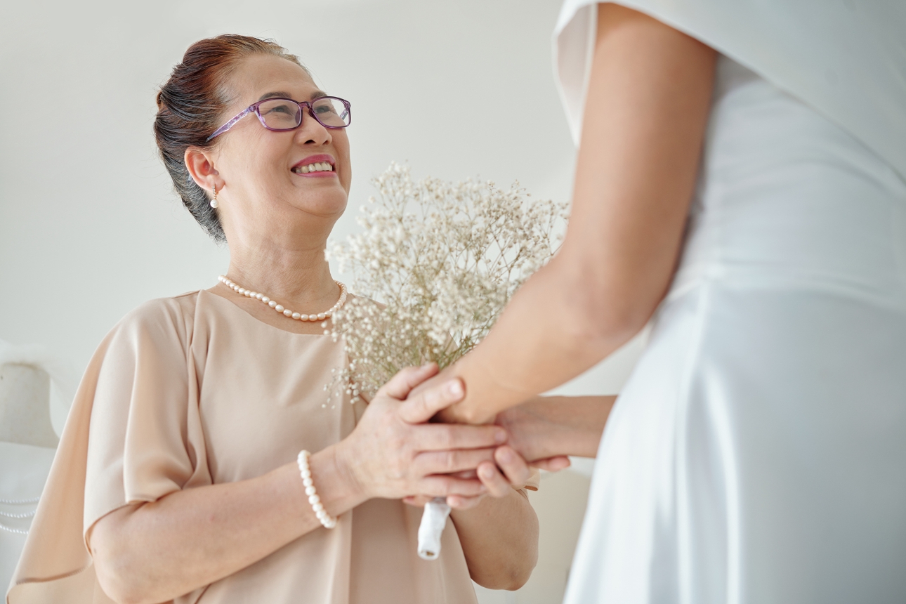 mother holding bride's hand