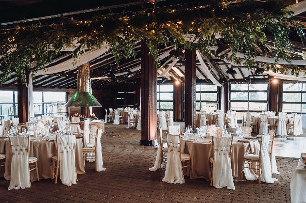 A room full of windows, oak beams and dressed tables