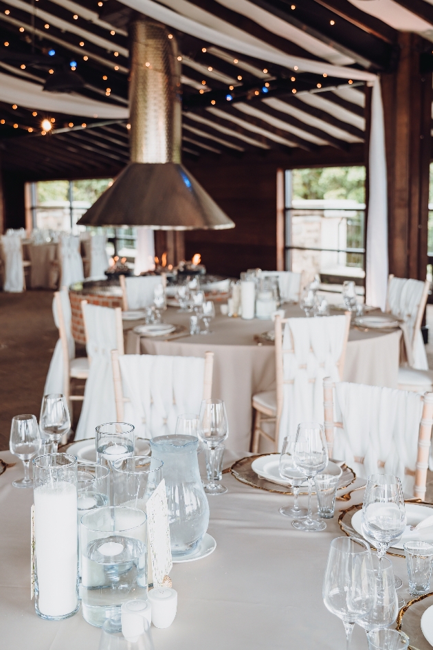 A close up of a round table with a white table cloth