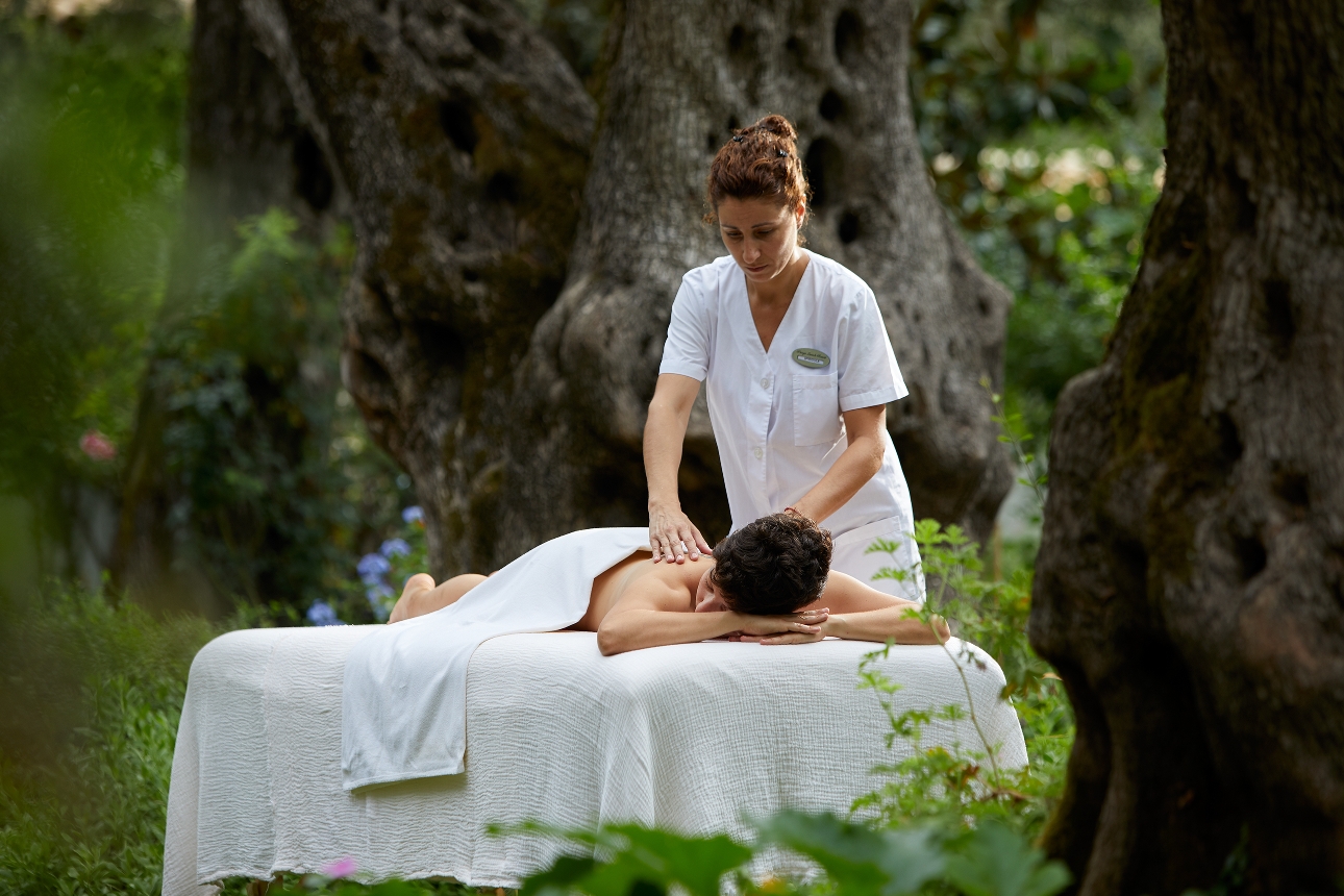 person on bed getting a massage