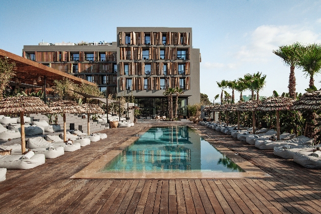 A swimming pool surrounded by sun loungers