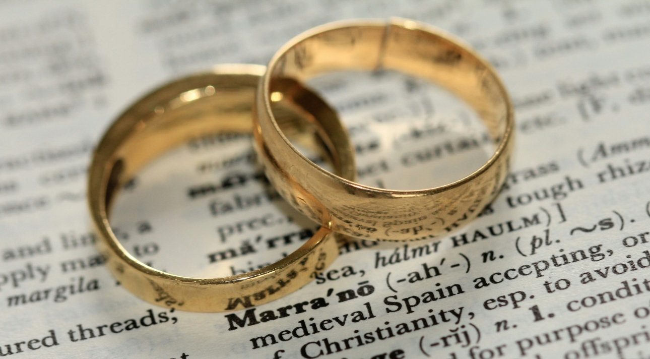two gold rings on a page with text 