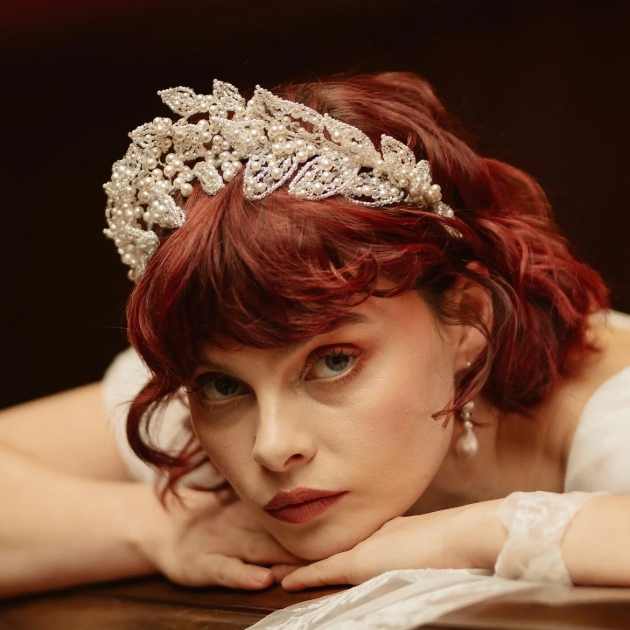lady laying down wearing crown