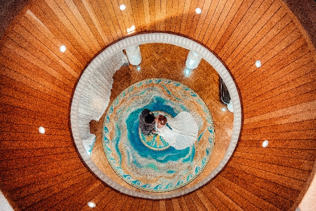 A birds eye view of a couple dancing on a blue rug