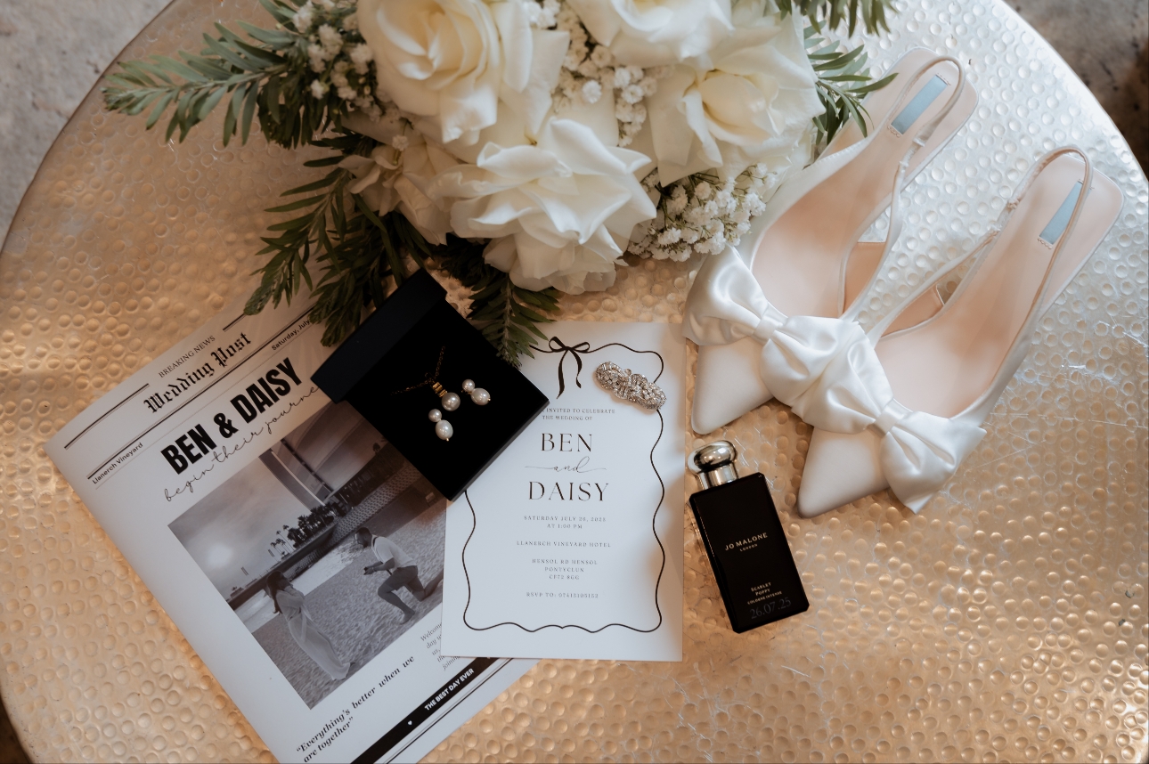 A bouquet next to shoes and earrings