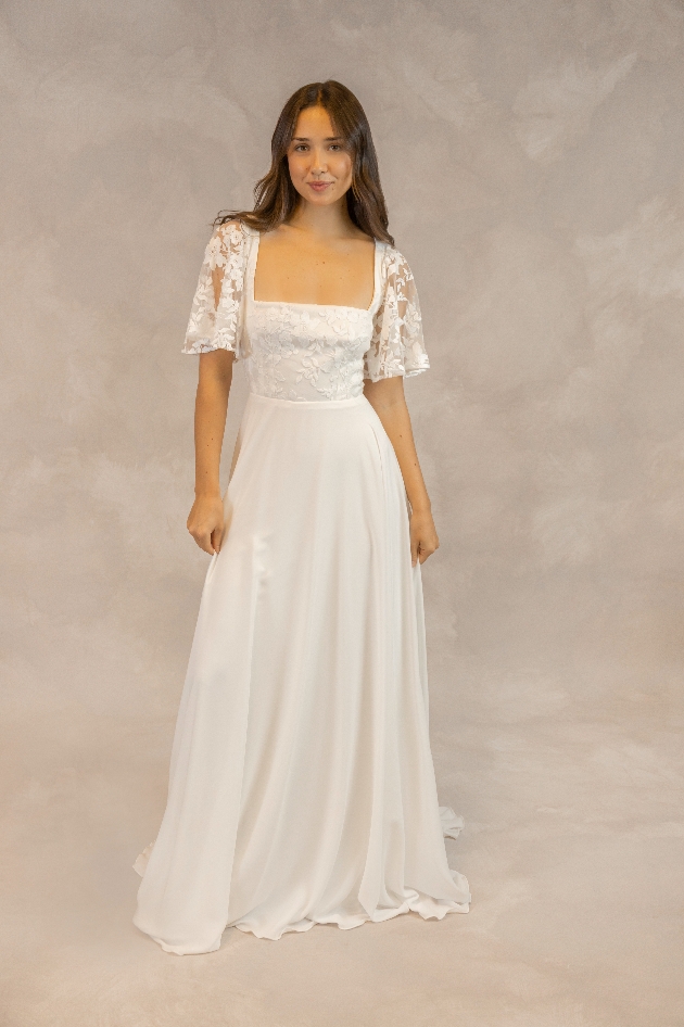 A woman wearing a lace wedding dress