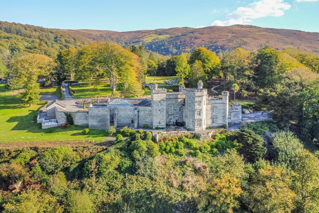 The exterior of a castle surrounded by countryside