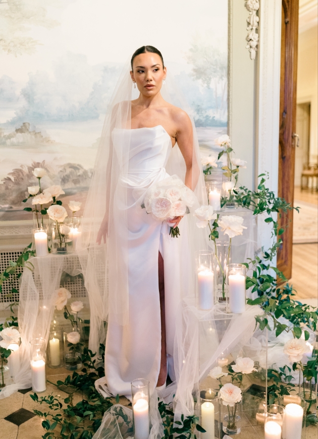 A satin drop-waist gown with hand draping across the bodice and skirt 