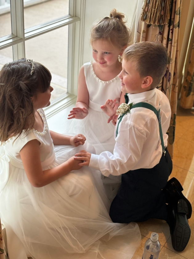 three children at a wedding playing