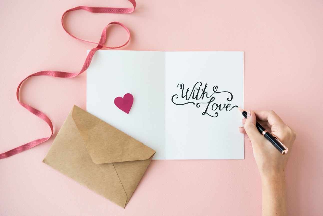someone writing in a card