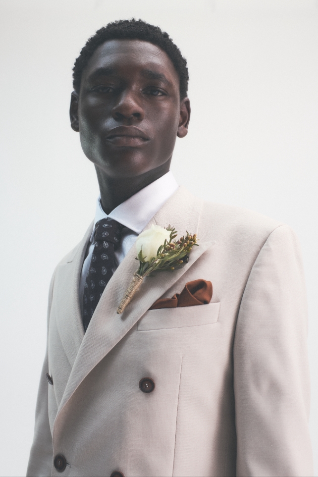 model in cream suit with autumn button hole